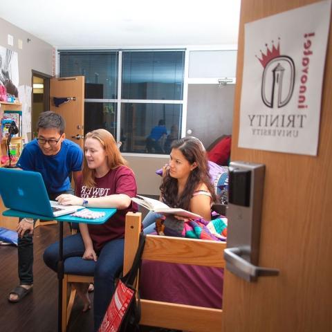 three students study together in an entrepreneurship hall dorm room